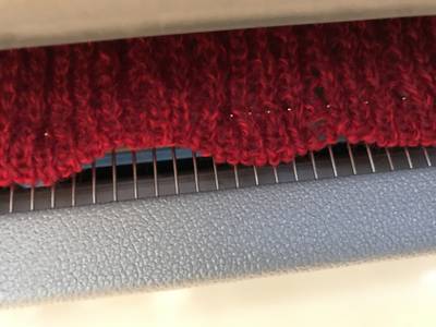 Small red blanket cast on comb